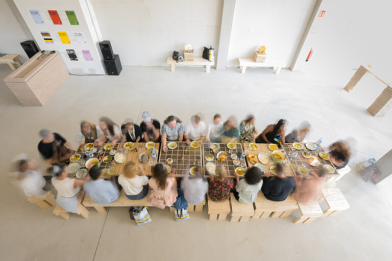 Personen um einen Tisch Viele Personen sitzen bei Tisch und essen