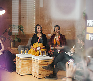 three people sittung together in a panel